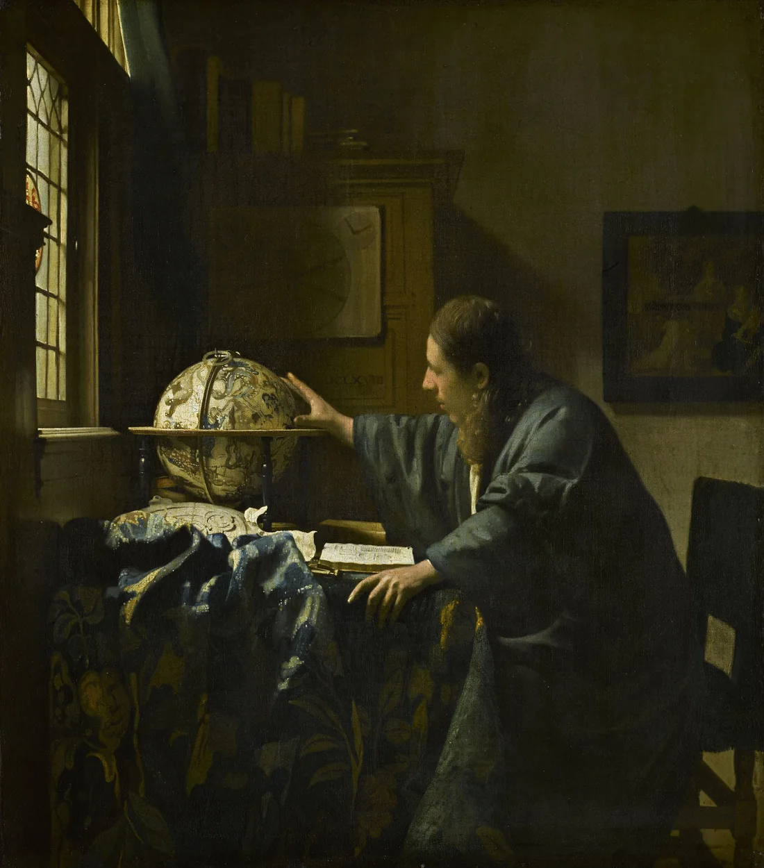Vermeer’s The Astronomer: a scholar in a blue robe reaches toward a celestial globe on a carpeted table, a book open before him, by a leaded window.