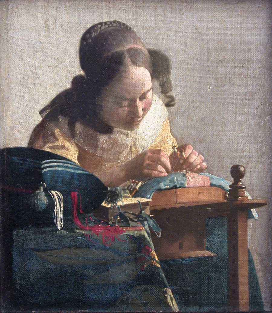 Vermeer’s The Lacemaker: a young woman in yellow bends close over her bobbins, threads of red and white spilling from a cushion.